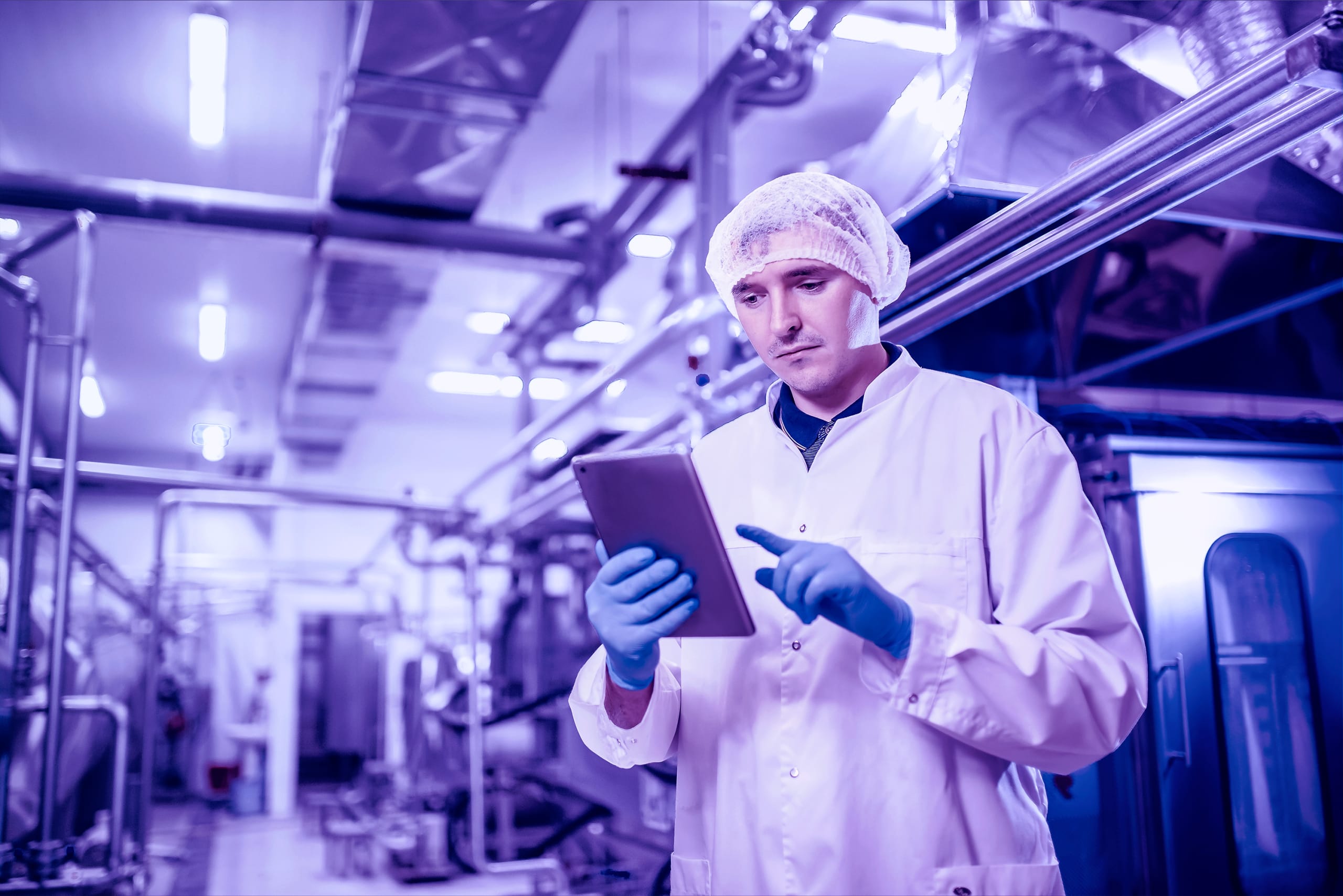 Food factory inspector looking at tablet