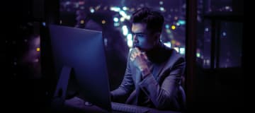 thoughtful man looking at computer screen