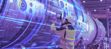 engineer uses tablet to scan pipeline construction with digital overlay