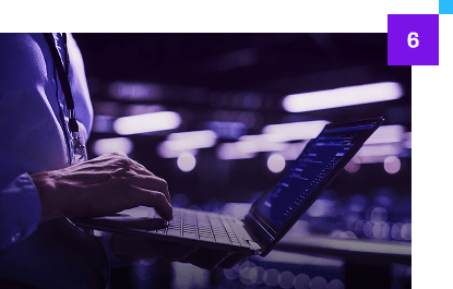 man holding laptop with number 6 in corner