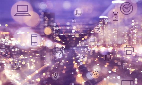cityscape with lights bokeh effect and device icons overlay