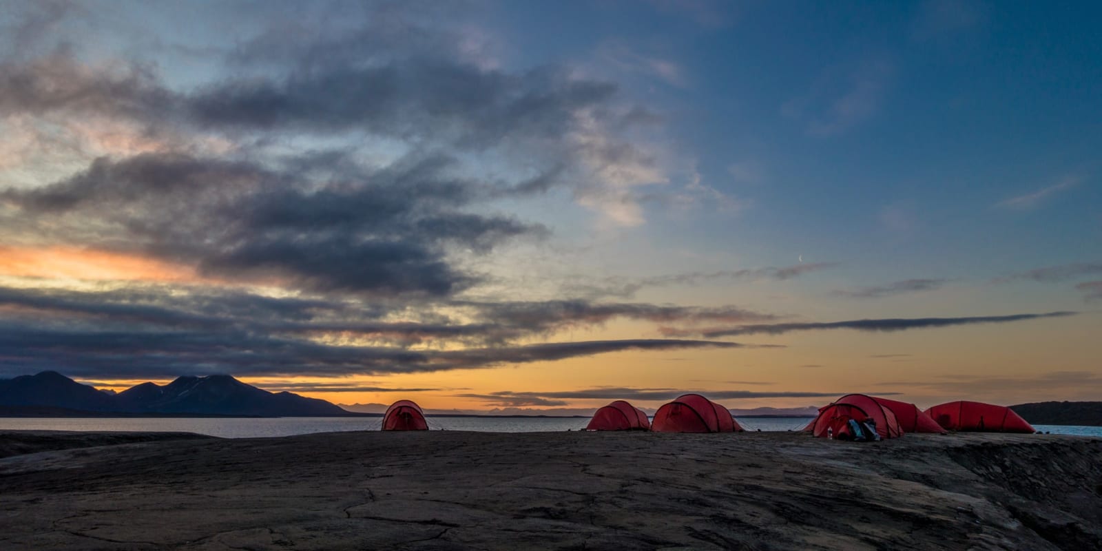 Campsite tents in Svalbard under midnight sun