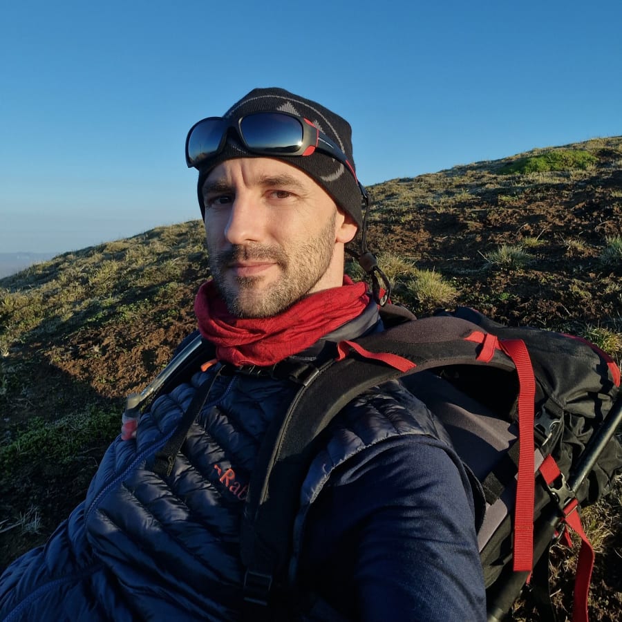 Arnar Ingi on a mountain hike with field gear