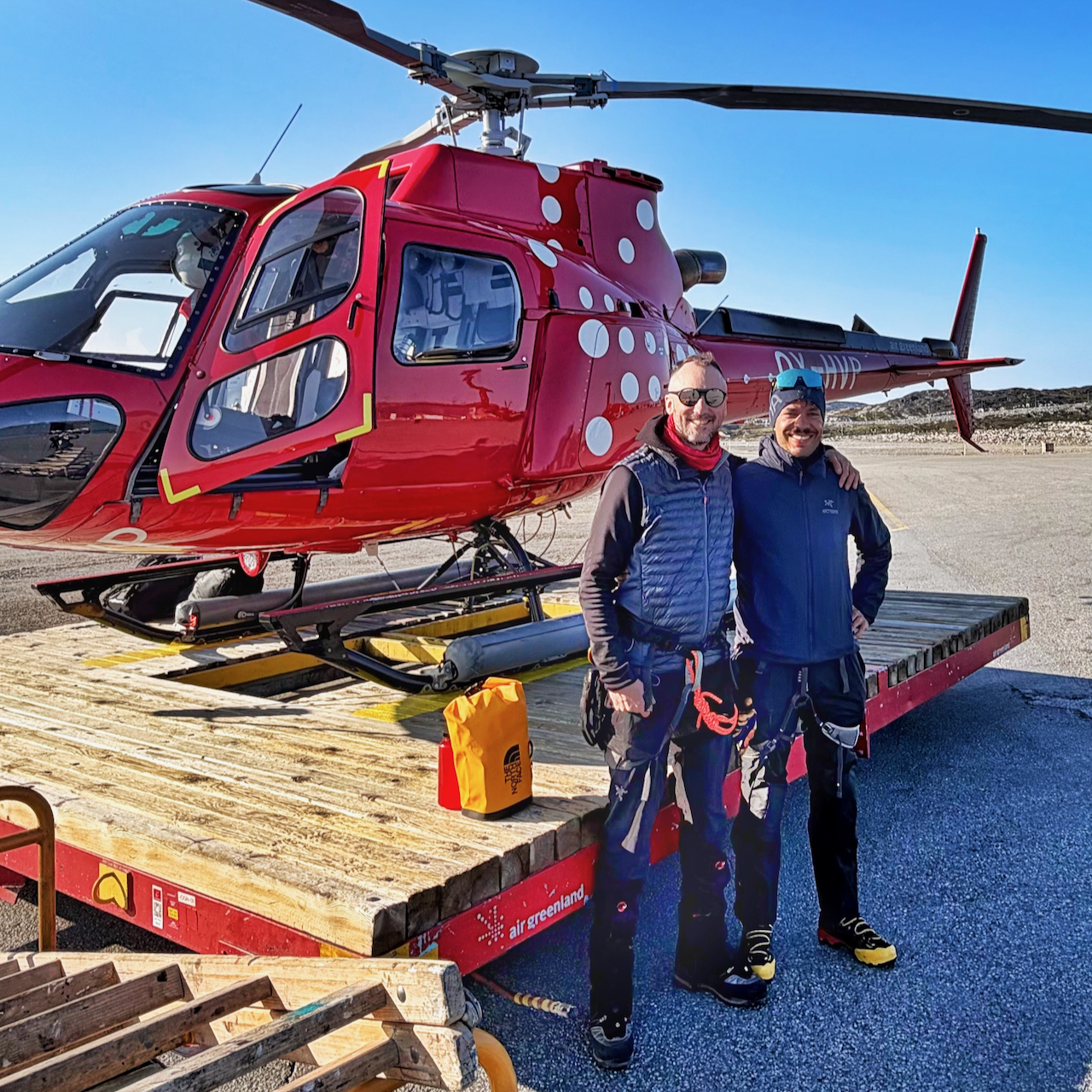 Swiss Camp field team beside a helicopter in Greenland