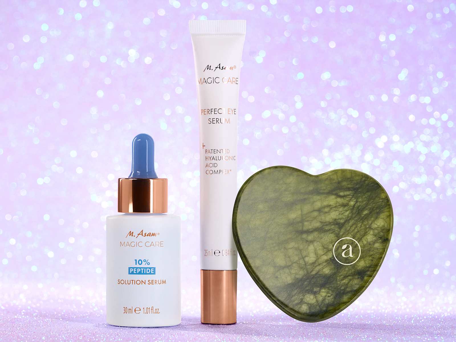 Drei M. Asam Beautyprodukte als Produktbild vor glitzerndem lila Hintergrund