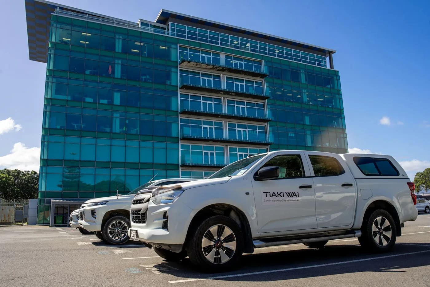 A company pickup truck parked in front of an office building