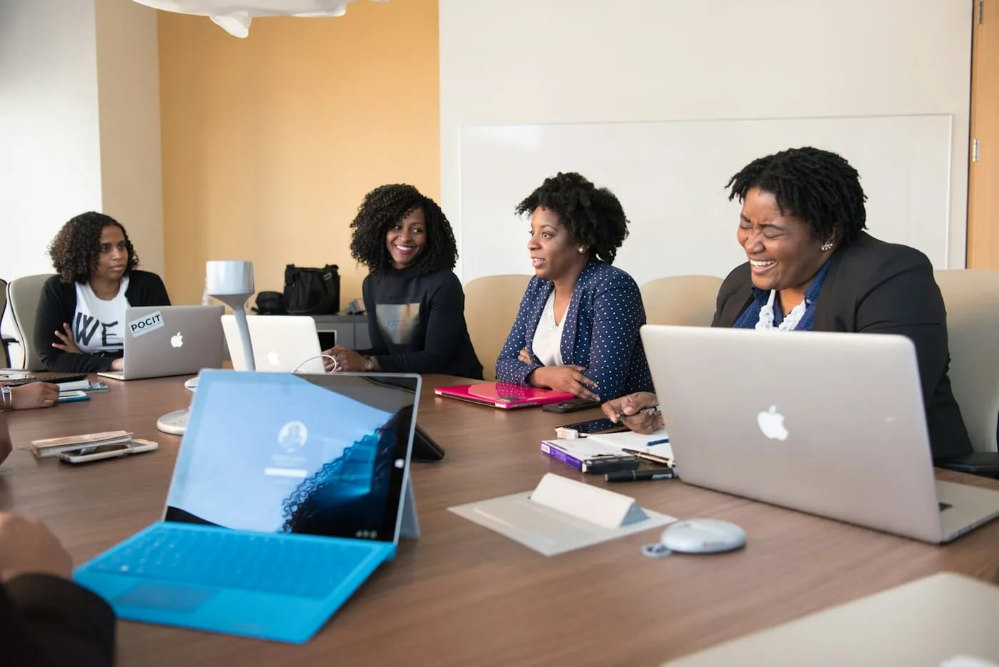 A team planning their rollout around a meeting table