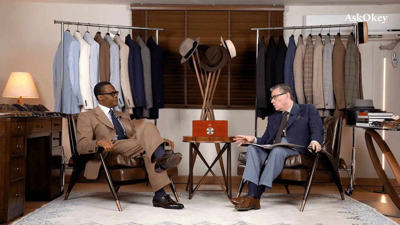 Okey in conversation with a client among the fabric rails