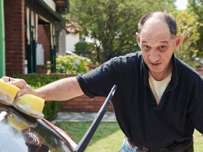 man washing car