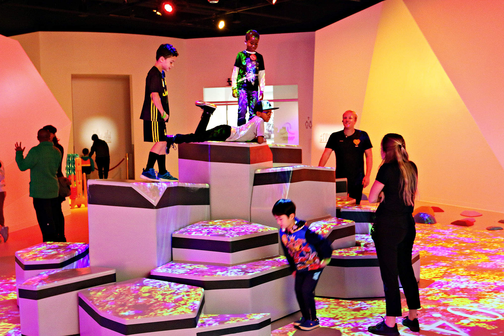 Kids climb, jump, and lay on padded blocks, guided by Playsmiths at a play space in Buckhead, called Kefi.