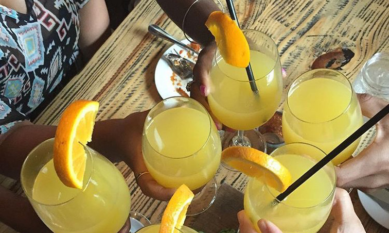 Friends toast mimosas at brunch at Meehan's Public House.
