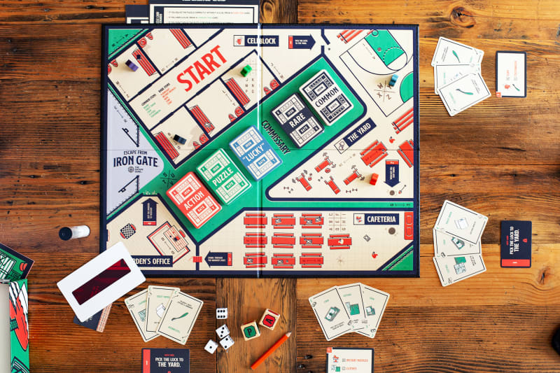 A tabletop view of an escape room board game that you can play at home, by The Escape Game Atlanta.