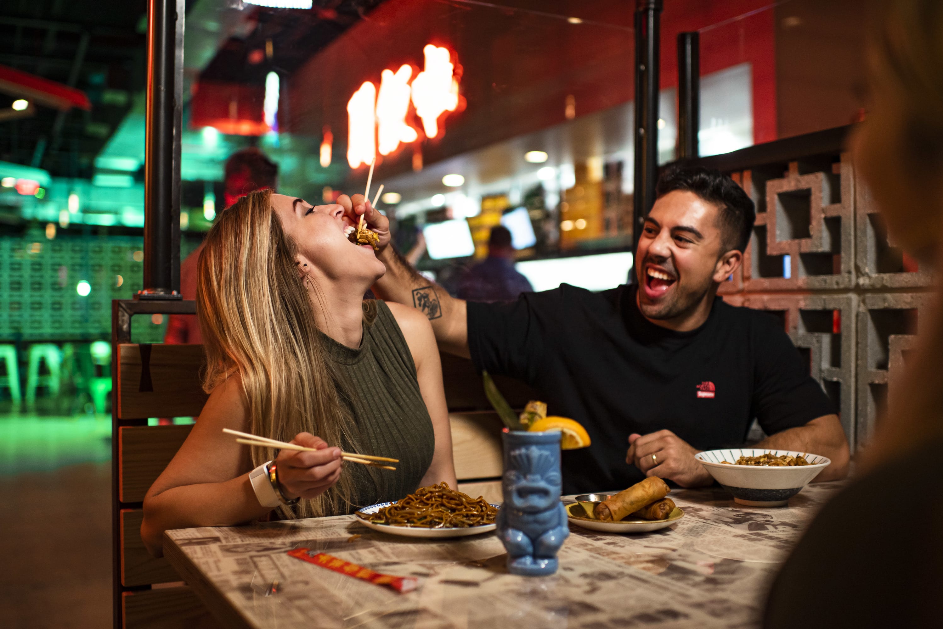 Tour Atlanta Beltline From Krog Street Market to Ponce City Market 2 A couple enjoys a lively meal at a Chinese restaurant, sharing food and laughter in Atlanta, Georgia.