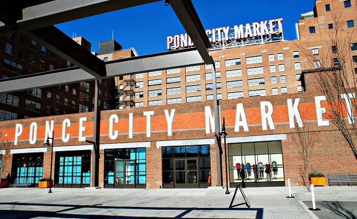A bustling market with a large sign reading 'Ponce City Market' above its entrance in Atlanta, Georgia.