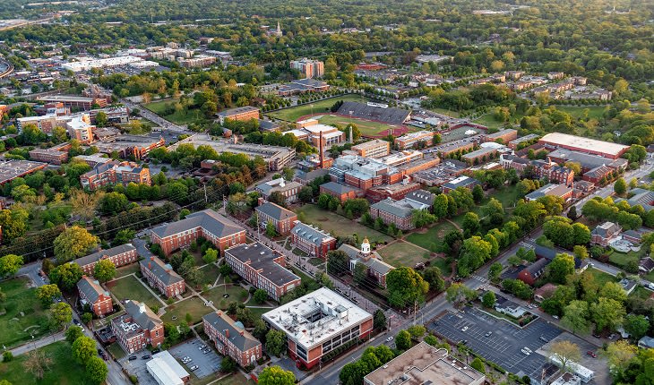 Aerial view of a college campus with red brick buildings and green spaces in Atlanta, Georgia.