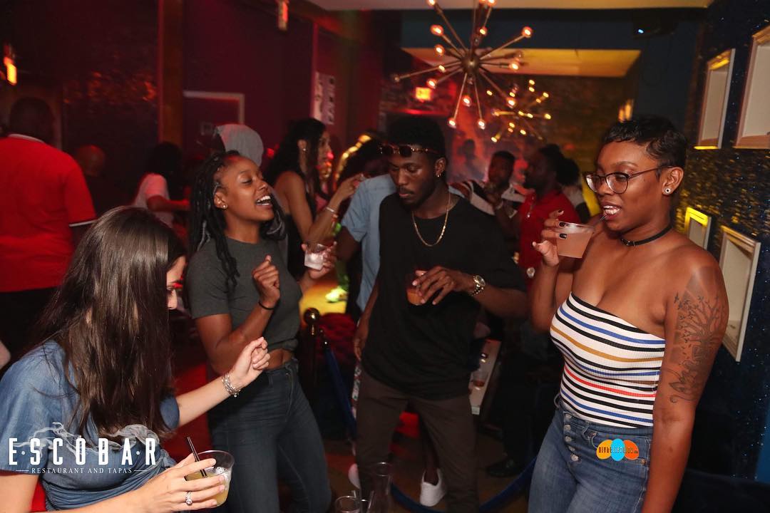 A lively nightclub scene with people dancing and enjoying drinks in Atlanta, Georgia.