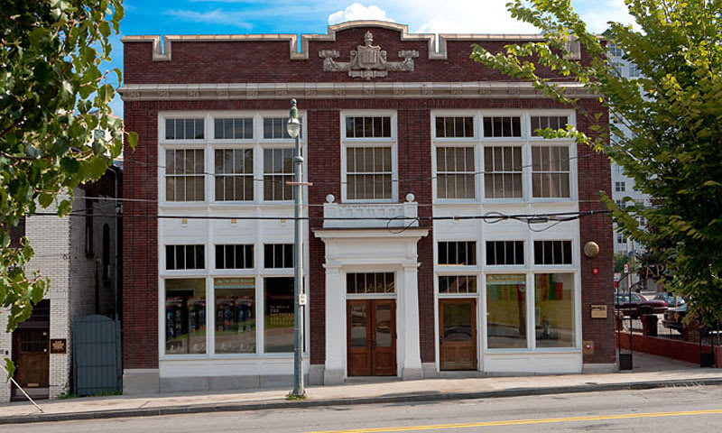 A three-story red brick building with white trim and large windows in Atlanta, Georgia.