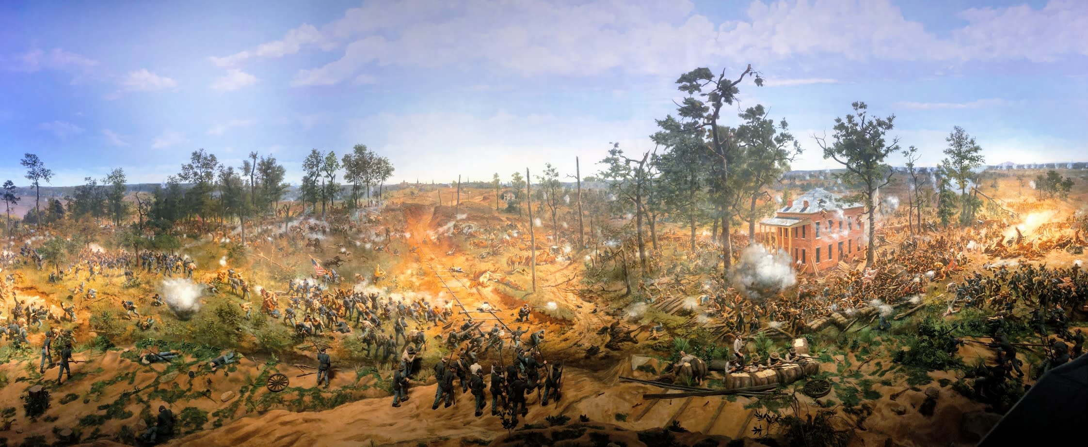 A panoramic painting depicts a Civil War battle with soldiers fighting amidst smoke and trees in Atlanta, Georgia.