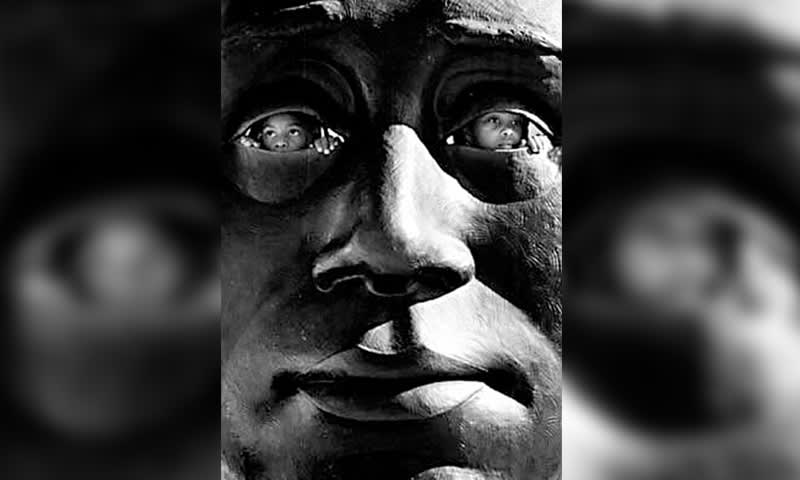 A black and white image of a face with eyes replaced by children's faces in Atlanta, Georgia.