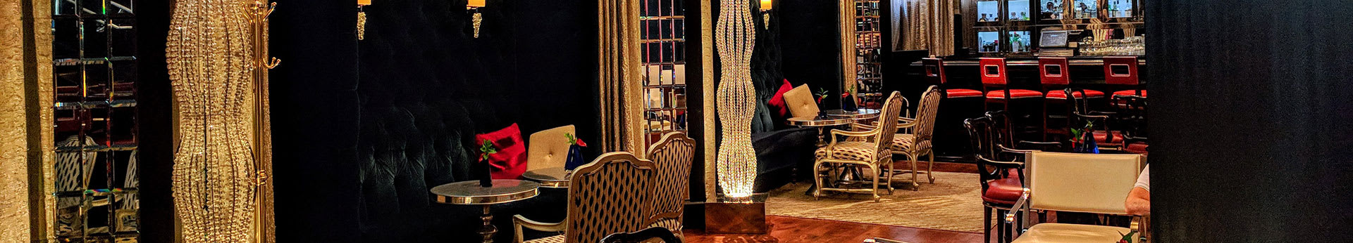 Elegant bar and lounge area with plush seating, crystal chandeliers, and a sophisticated atmosphere in Atlanta, Georgia.