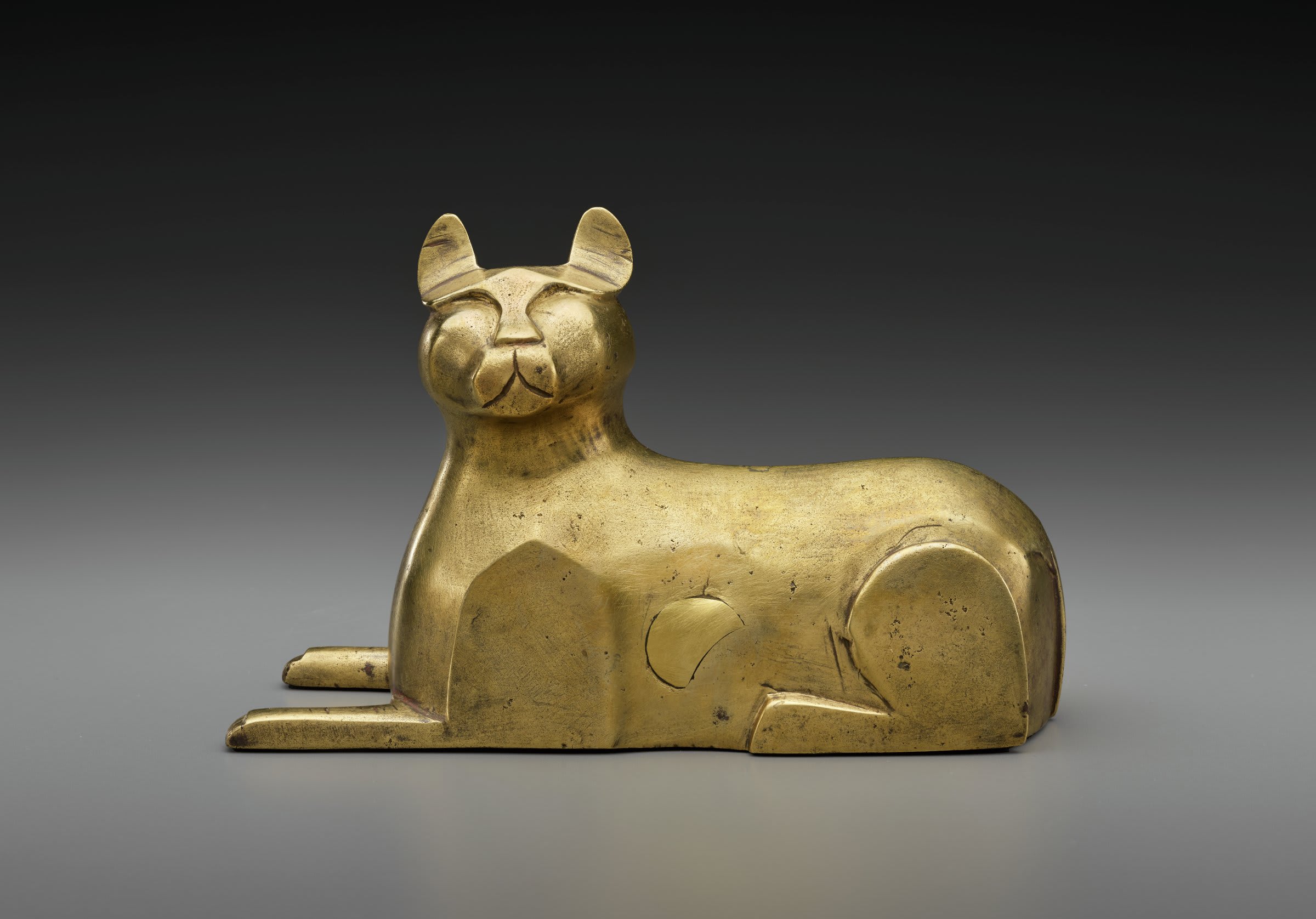 Golden cat statue with abstract, stylized features and a smooth, polished finish in Atlanta, Georgia.