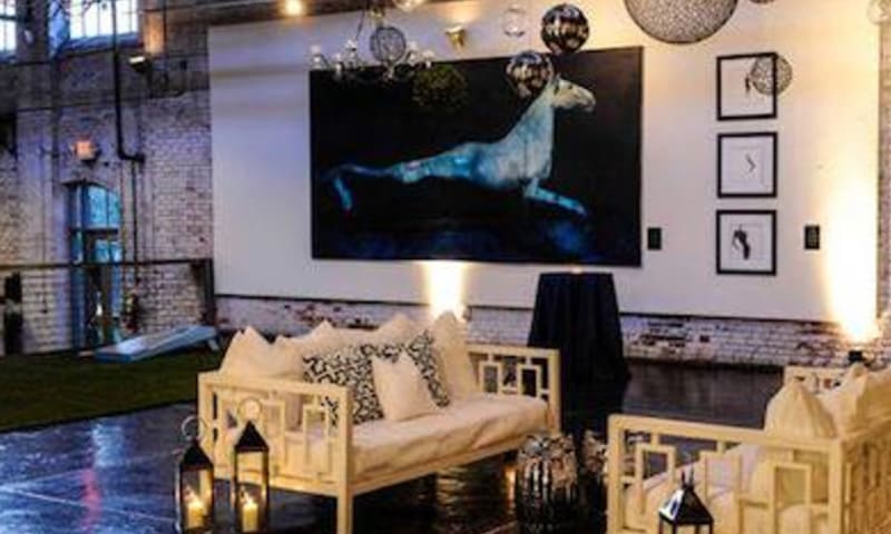 Modern living room with white sofa, black and white pillows, and large horse painting in Atlanta, Georgia.