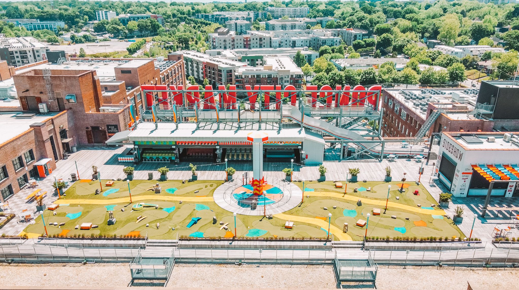 Aerial view of a vibrant urban park with colorful playground equipment and surrounding buildings in Atlanta, Georgia.