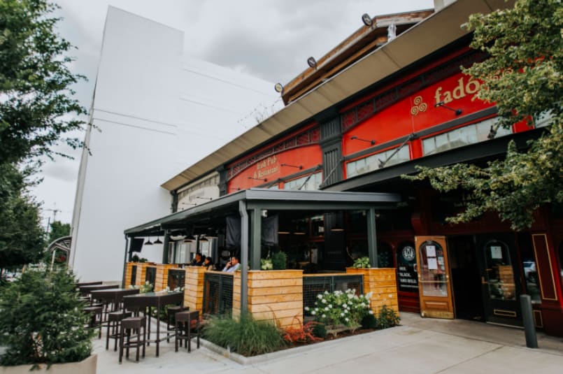 A vibrant red restaurant with outdoor seating and a modern design in Atlanta, Georgia.