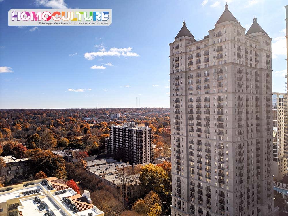 Aerial view of a city skyline with a tall building and autumn-colored trees in Atlanta, Georgia.