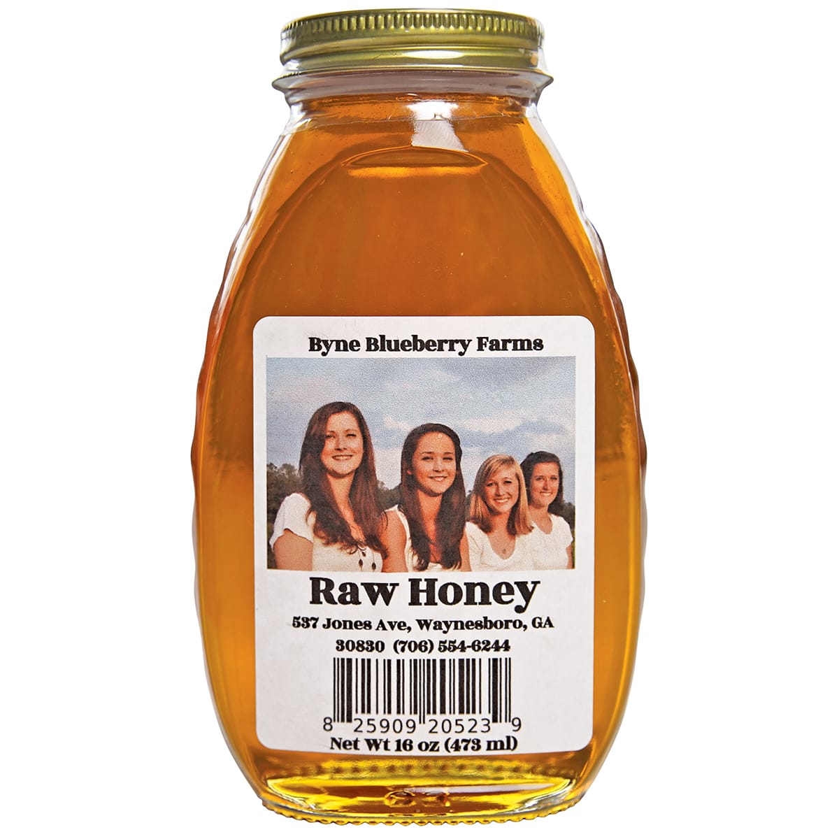 Four smiling women stand in a field with a blue sky behind them in Atlanta, Georgia.