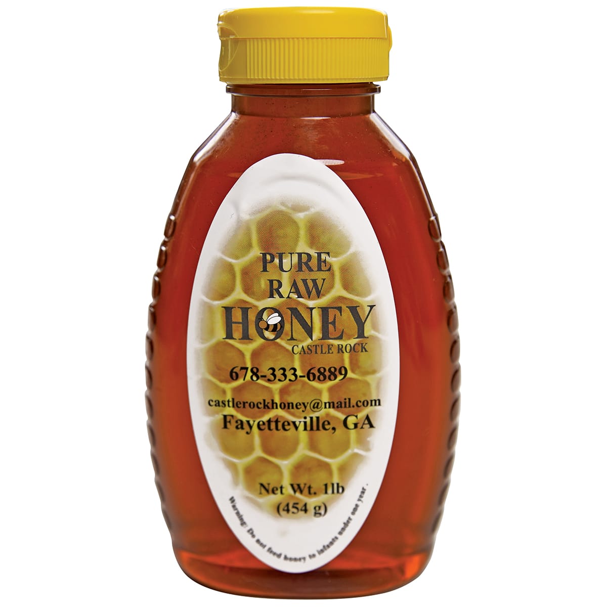A bottle of raw honey with a yellow cap and label featuring a honeycomb design in Atlanta, Georgia.