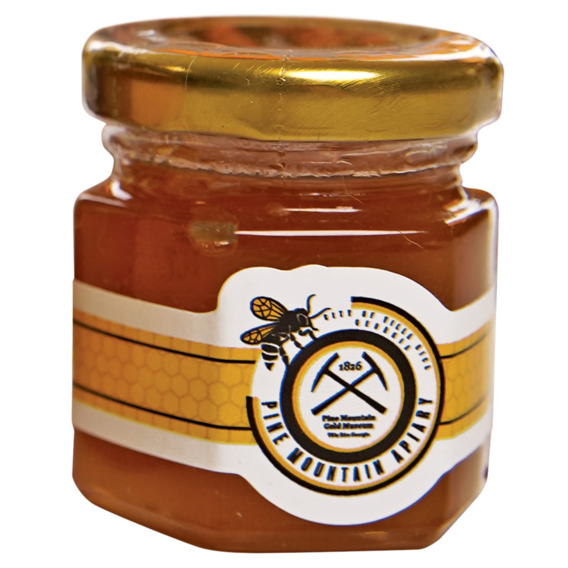 A small jar of honey with a golden lid and a label featuring a bee and crossed pickaxes in Atlanta, Georgia.