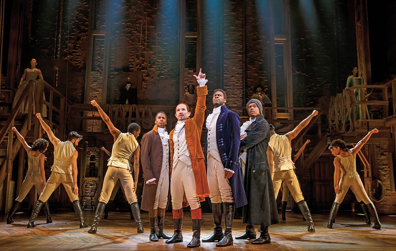 Cast of Hamilton musical performing on stage with dramatic lighting and costumes in Atlanta, Georgia.
