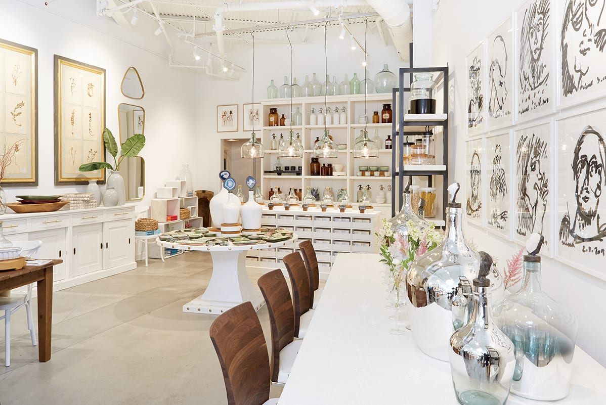A minimalist interior with white walls, wooden furniture, and glass vases in Atlanta, Georgia.