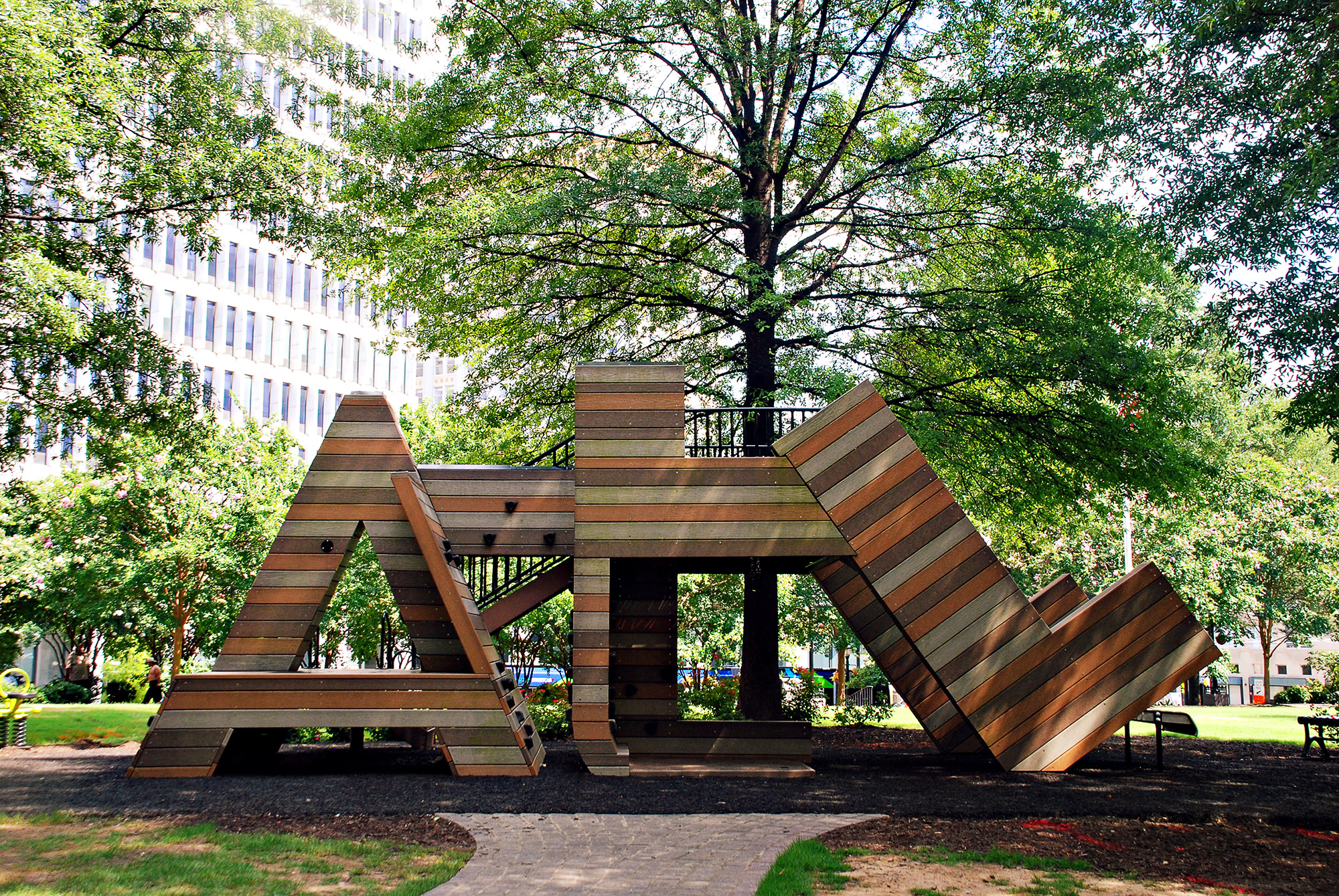 A wooden playground structure resembling a giant 'A' with slides and climbing areas in Atlanta, Georgia.