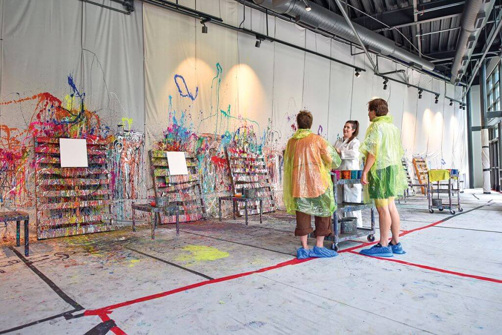 A couple making art at The Splatter Studio in Atlanta, a fun date night idea.