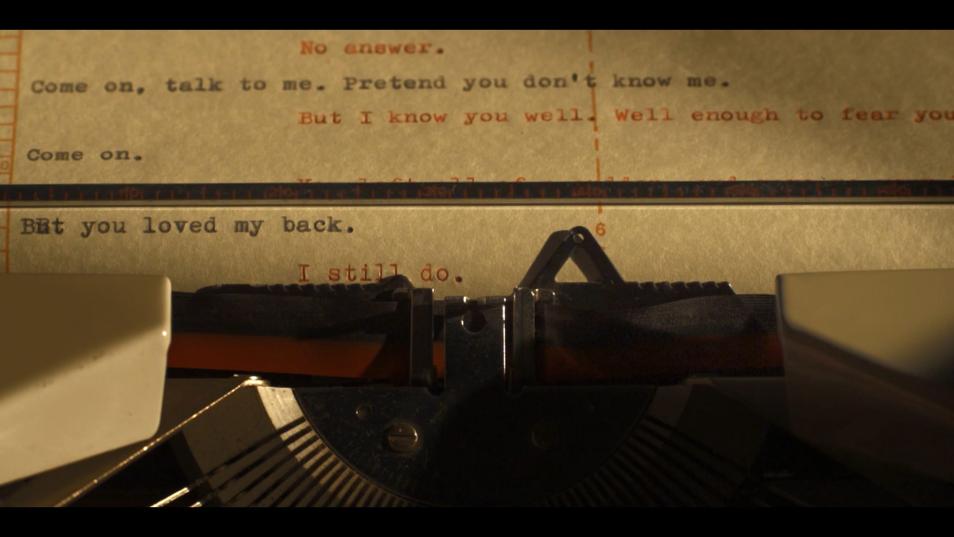 A vintage typewriter with red ribbon types a letter on yellowed paper in Atlanta, Georgia.