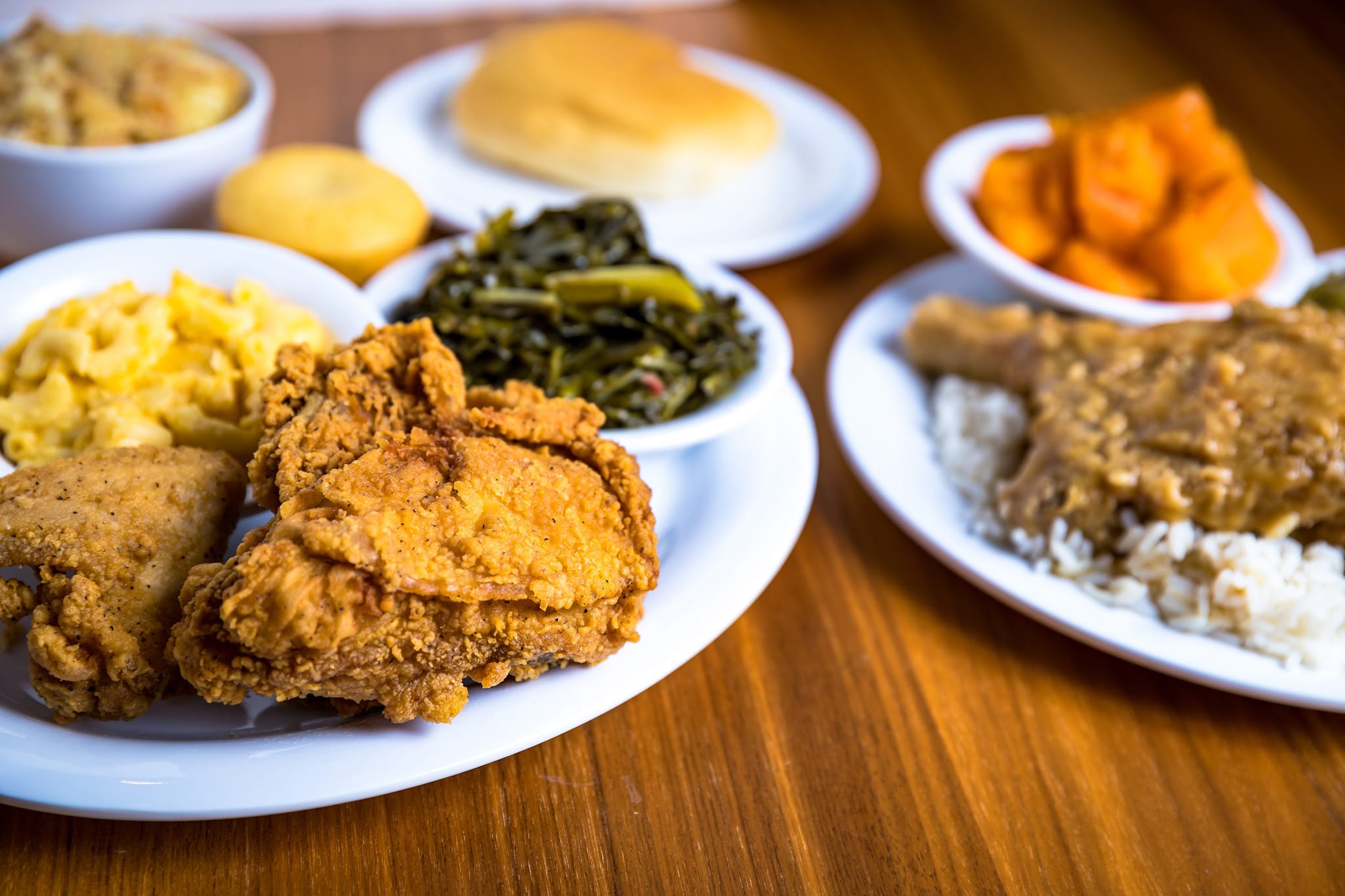 A plate of fried chicken with sides of greens, macaroni and cheese, and mashed potatoes in Atlanta, Georgia.