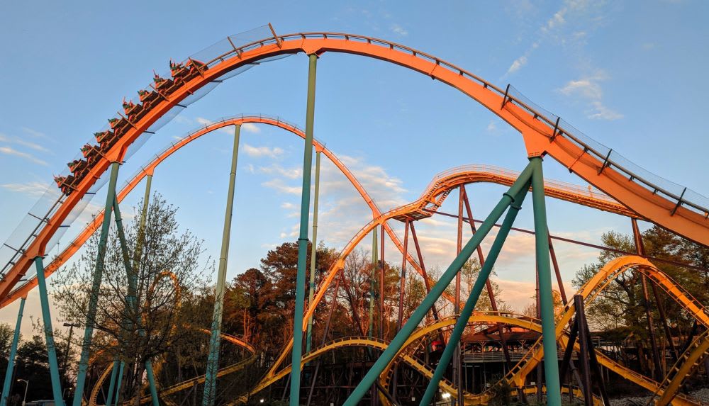 A thrilling roller coaster with multiple loops and twists against a colorful sky in Atlanta, Georgia.