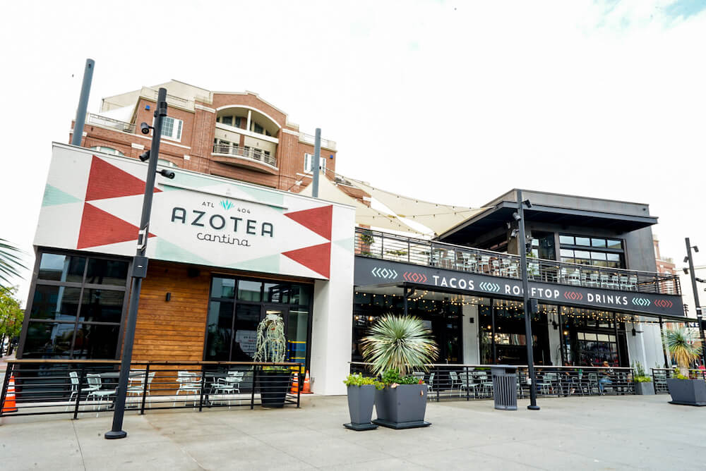 A modern restaurant with a colorful facade and outdoor seating area in Atlanta, Georgia.