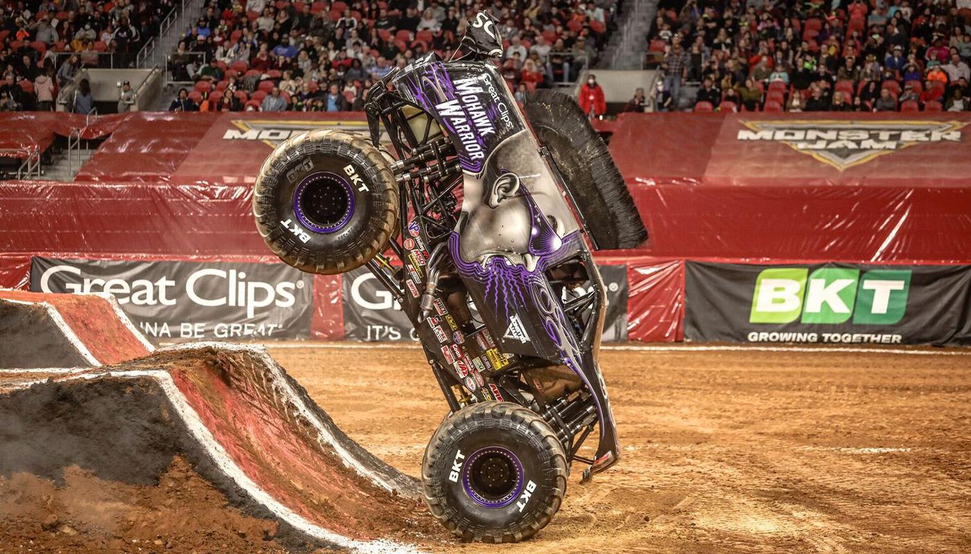 Monster truck performing a daring aerial stunt at a Monster Jam event in Atlanta, Georgia.