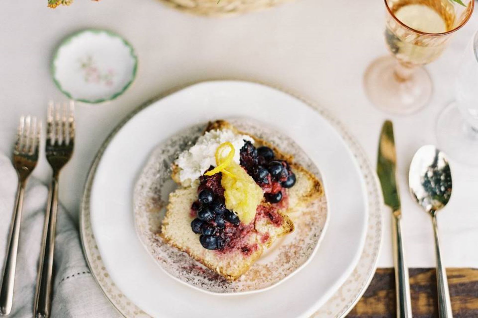 A beautifully set table with a dessert plate featuring pound cake topped with berries and whipped cream in Atlanta, Georgia.