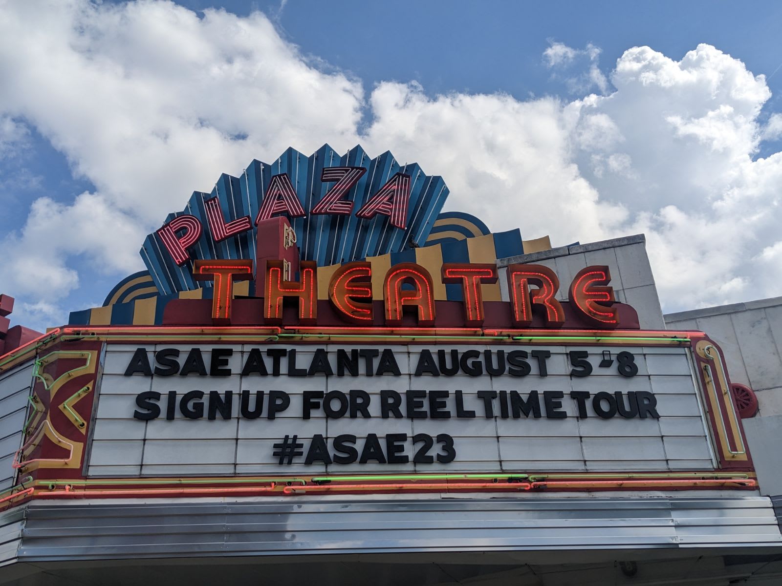 A vintage-style movie theater marquee advertises an upcoming event with a hashtag in Atlanta, Georgia.