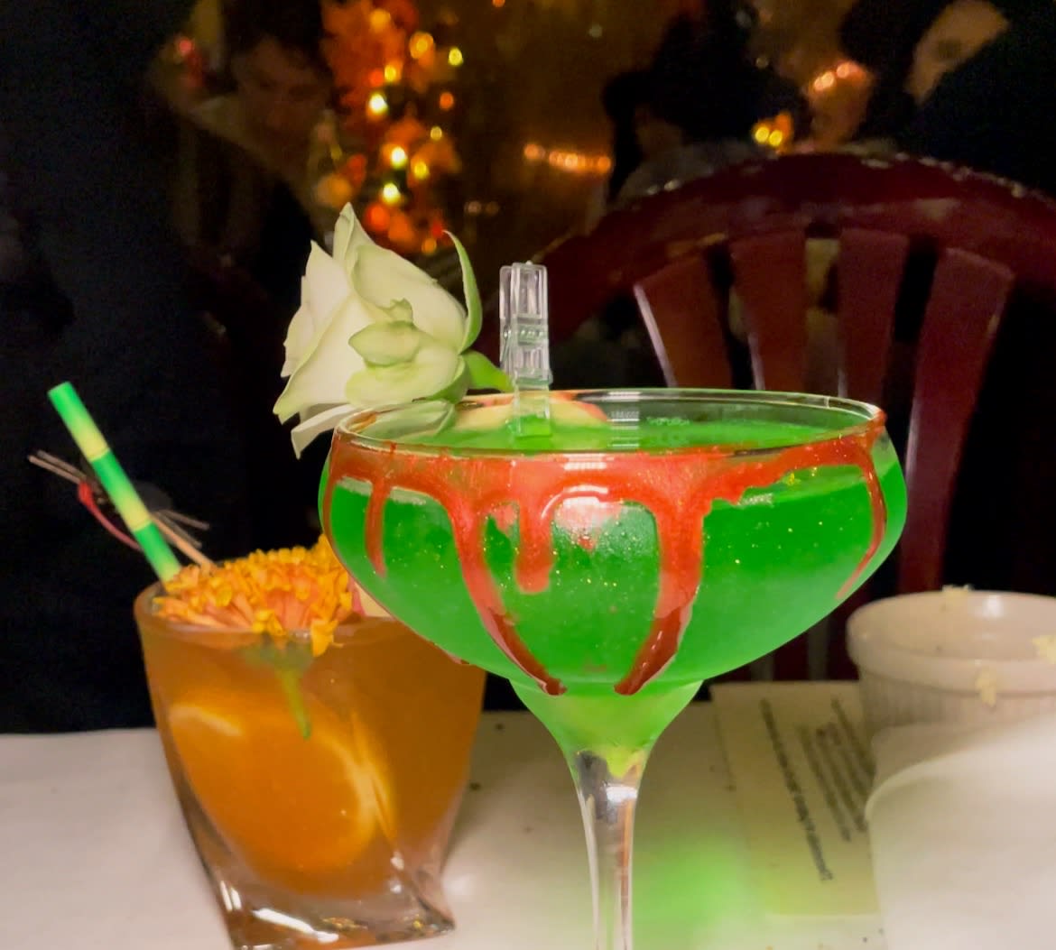 Two festive cocktails with vibrant colors and decorative garnishes on a table in Atlanta, Georgia.