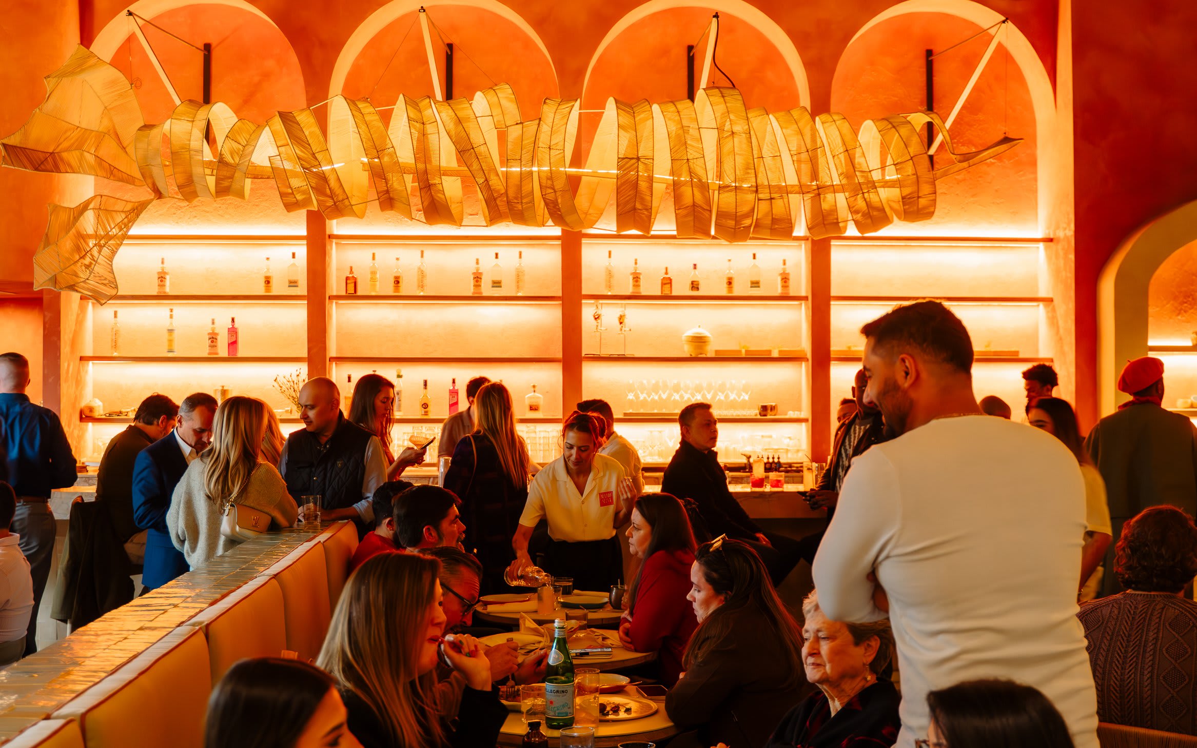 A lively restaurant scene with patrons dining and socializing at tables and the bar in Atlanta, Georgia.