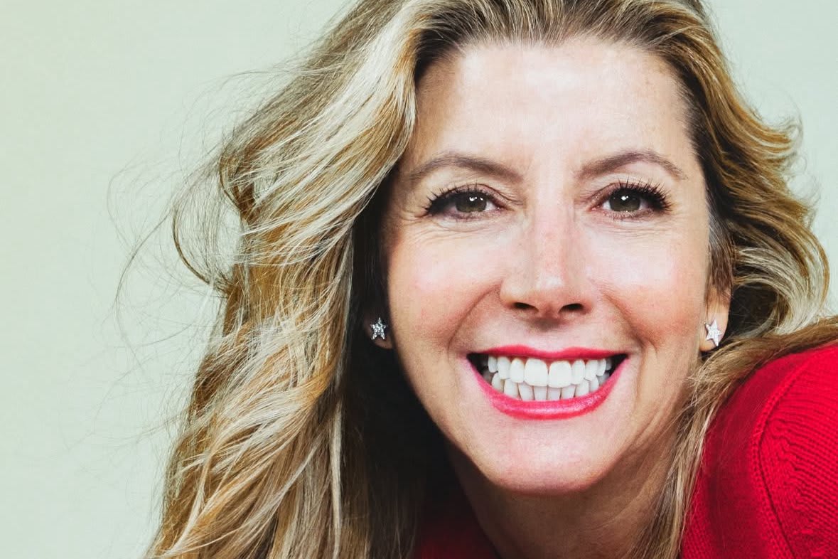 A smiling woman with blonde hair and red lipstick poses for a portrait in Atlanta, Georgia.
