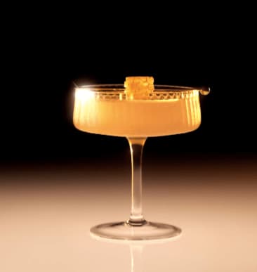 Ultimate Guide to Attending Beyoncé's Cowboy Carter Tour in Atlanta 3 A golden cocktail with a honey-colored liquid and a honey comb garnish in a martini glass in Atlanta, Georgia.