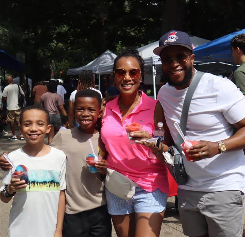Atlanta Ice Cream Festival Celebrates 15 Sweet Years at Piedmont Park 3 A family of four enjoys snow cones at an outdoor summer event in Atlanta, Georgia.