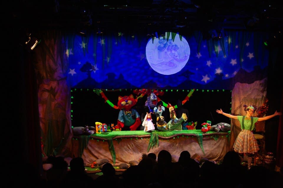 A whimsical stage performance featuring colorful puppets and characters under a starry night sky in Atlanta, Georgia.