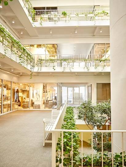 How to Shop at AmericasMart Atlanta 2 A modern, multi-story building with indoor plants and glass railings in Atlanta, Georgia.